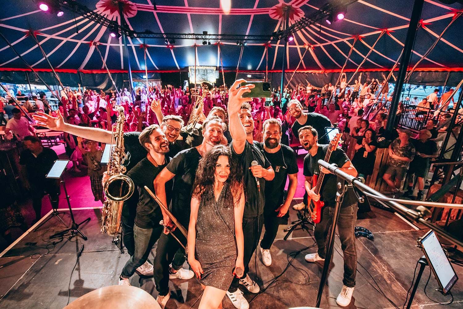 Brass Tacks Live Band at an afterparty, surrounded by the crowd